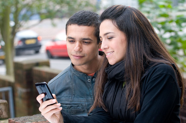 Guy and girl with mobile phone