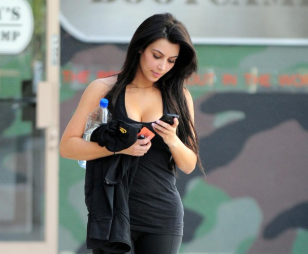 Beautiful girl texting while walking