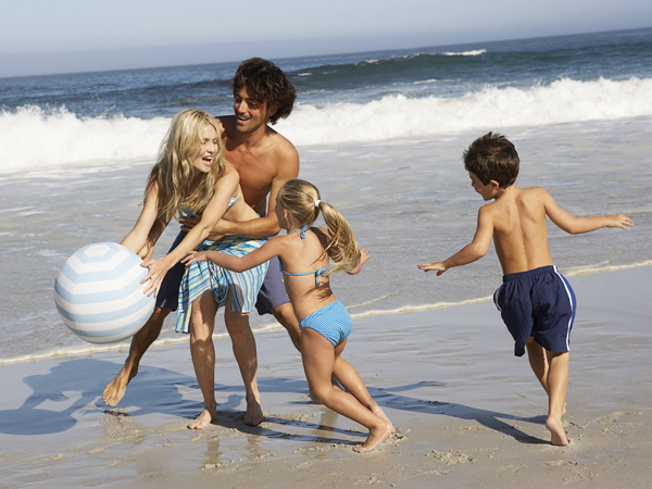 Family with kids on the beach